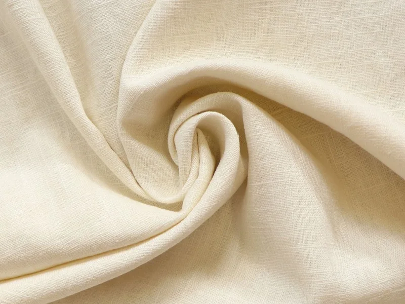 Folds of soft cream cotton fabric